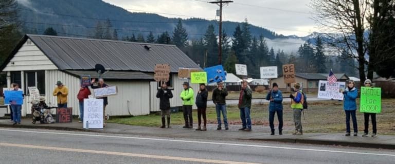 About twenty people with signs on the main street of Darrington, Wa Jan 10, 2026